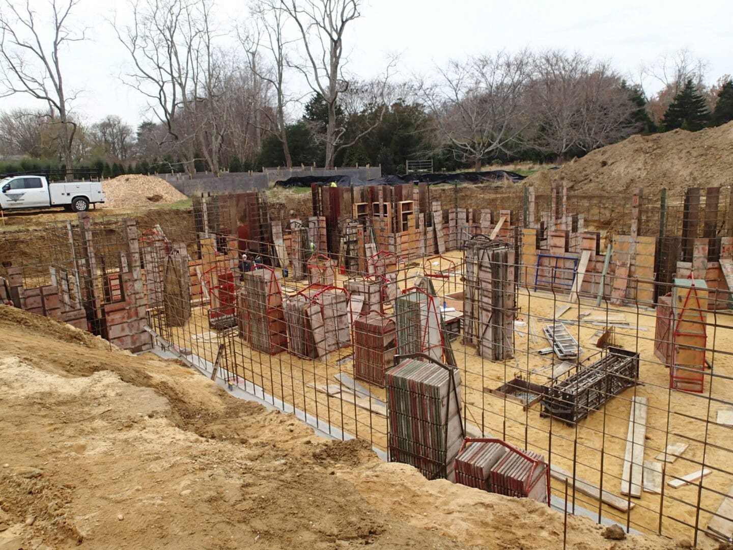 A construction site with many piles of bricks.
