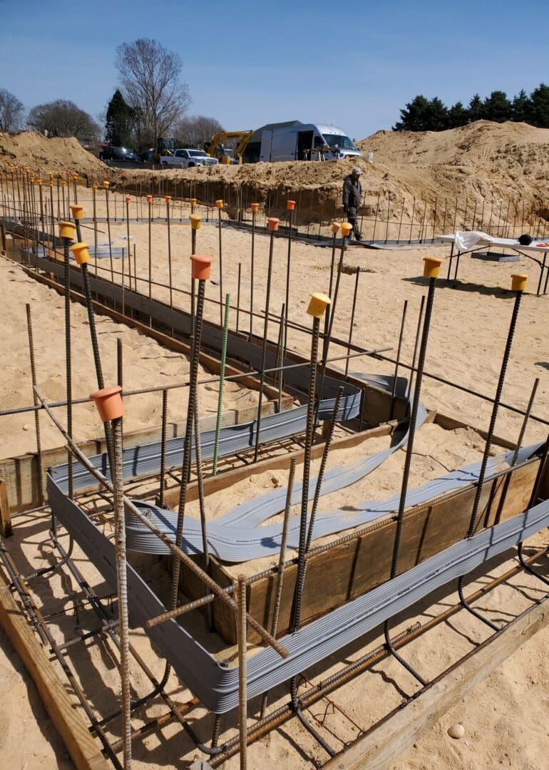 A construction site with many metal bars on the ground.