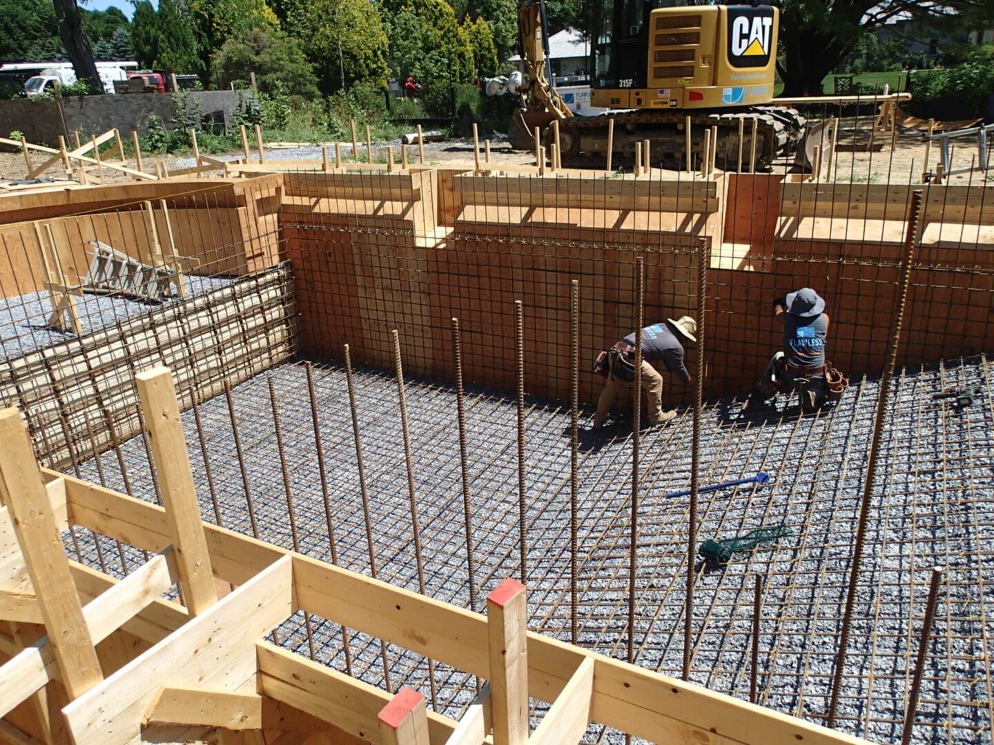 A construction site with workers working on the ground.
