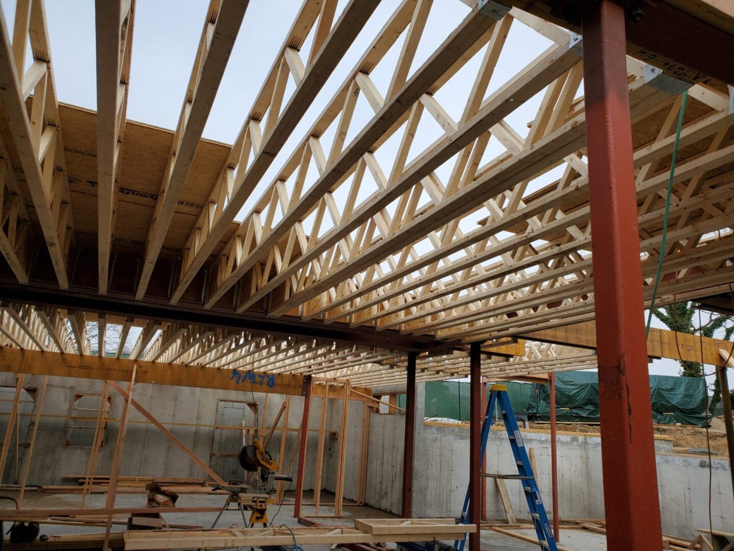 A building under construction with scaffolding and wooden beams.