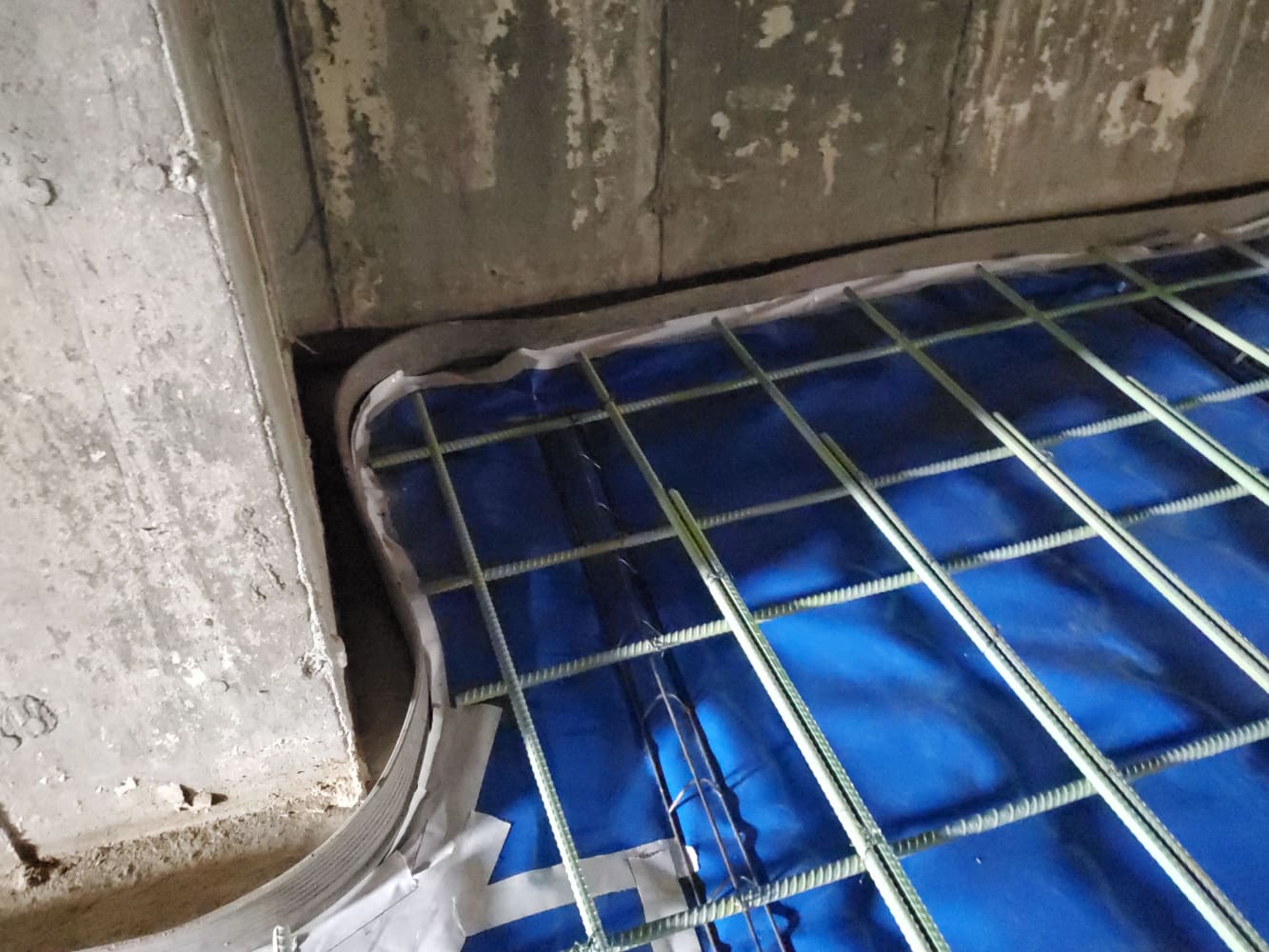A blue floor with metal bars on it