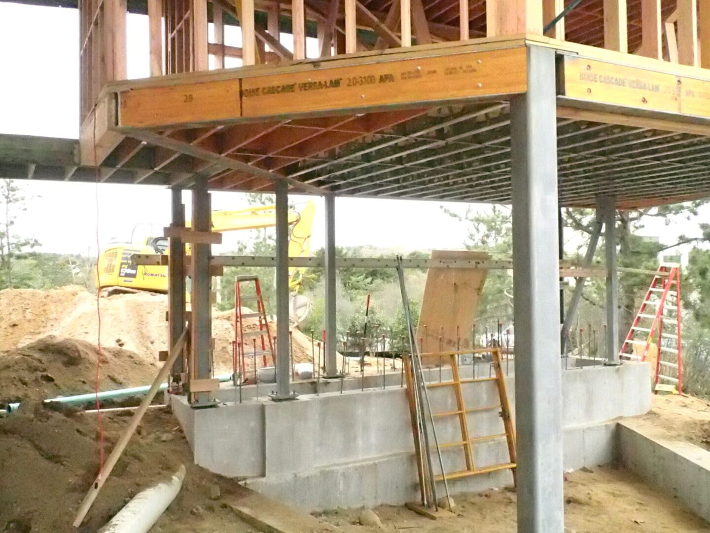 A construction site with a person standing on the ground.